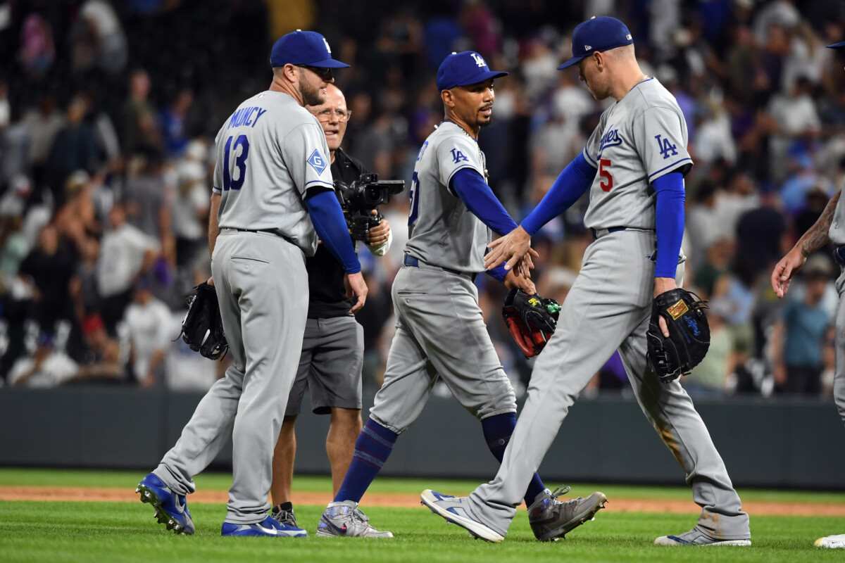 Aug 18, 2026; Denver, Colorado, USA; Los Angeles Dodgers infielder Mookie Betts (50) celebrates with infielder Max Muncy (13) and infielder Freddie Freeman (5) after a win against the Colorado Rockies at Coors Field. Mandatory Credit: Christopher Hanewinckel-Imagn Images