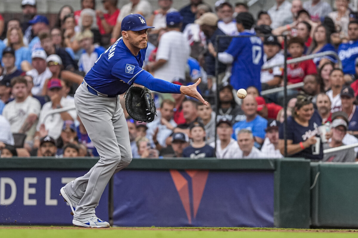 Aug 27, 2026; Cumberland, Georgia, USA; Los Angeles Dodgers first baseman Freddie Freeman (5) flips the ball to pitcher Yoshinobu Yamamoto (18) (not shown) for a force out on Atlanta Braves first baseman Matt Olson (28) (not shown) during the first inning at Truist Park. Mandatory Credit: Dale Zanine-Imagn Images