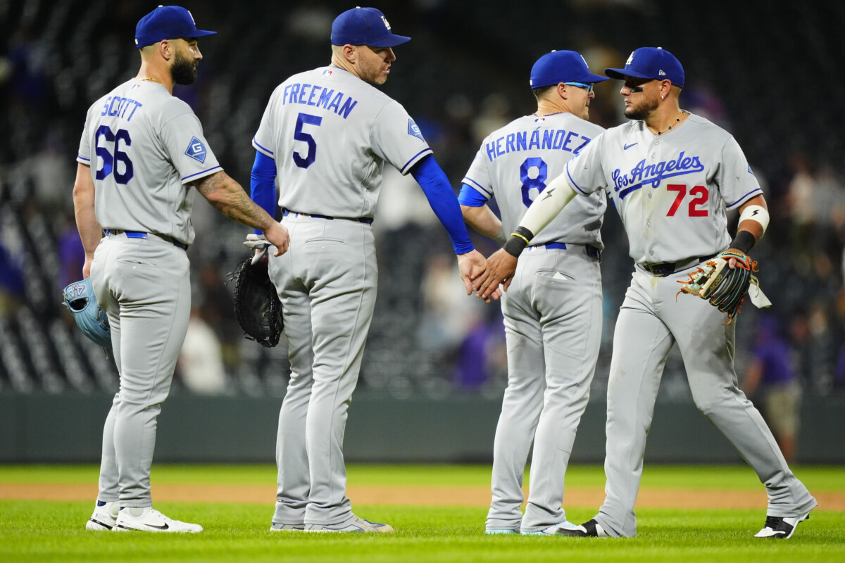 Aug 19, 2026; Denver, Colorado, USA; Los Angeles Dodgers second baseman Miguel Rojas (72), second baseman Enrique Hernandez (8), first baseman Freddie Freeman (5) and relief pitcher Tanner Scott (66) celebrate the tenth inning win against the Colorado Rockies at Coors Field. Mandatory Credit: Ron Chenoy-Imagn Images