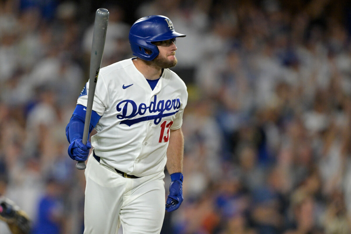 Aug 11, 2026; Los Angeles, California, USA; Los Angeles Dodgers third baseman Max Muncy (13) hits a walk-off single to defeat the Kansas City Royals in the tenth inning at Dodger Stadium. Mandatory Credit: Jayne Kamin-Oncea-Imagn Images