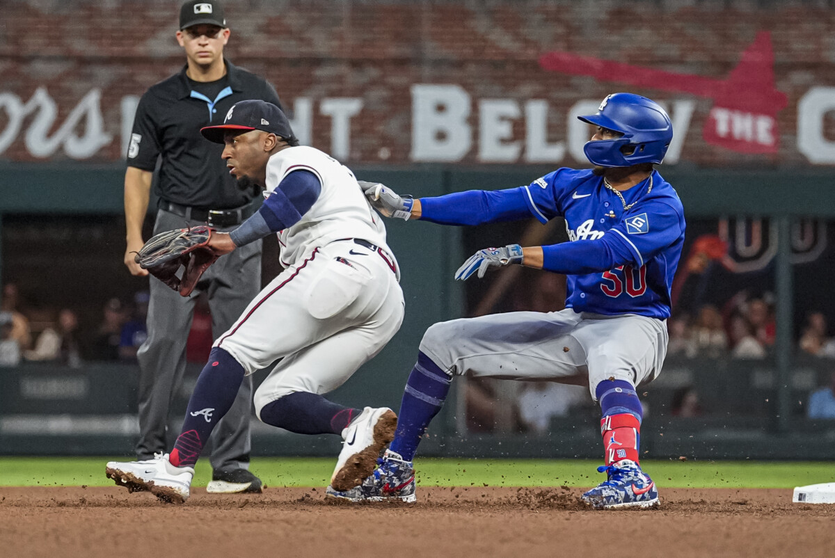 Aug 27, 2026; Cumberland, Georgia, USA; Los Angeles Dodgers shortstop Mookie Betts (50) runs into Atlanta Braves second baseman Ozzie Albies (1) after hitting a double during the fourth inning at Truist Park. Mandatory Credit: Dale Zanine-Imagn Images