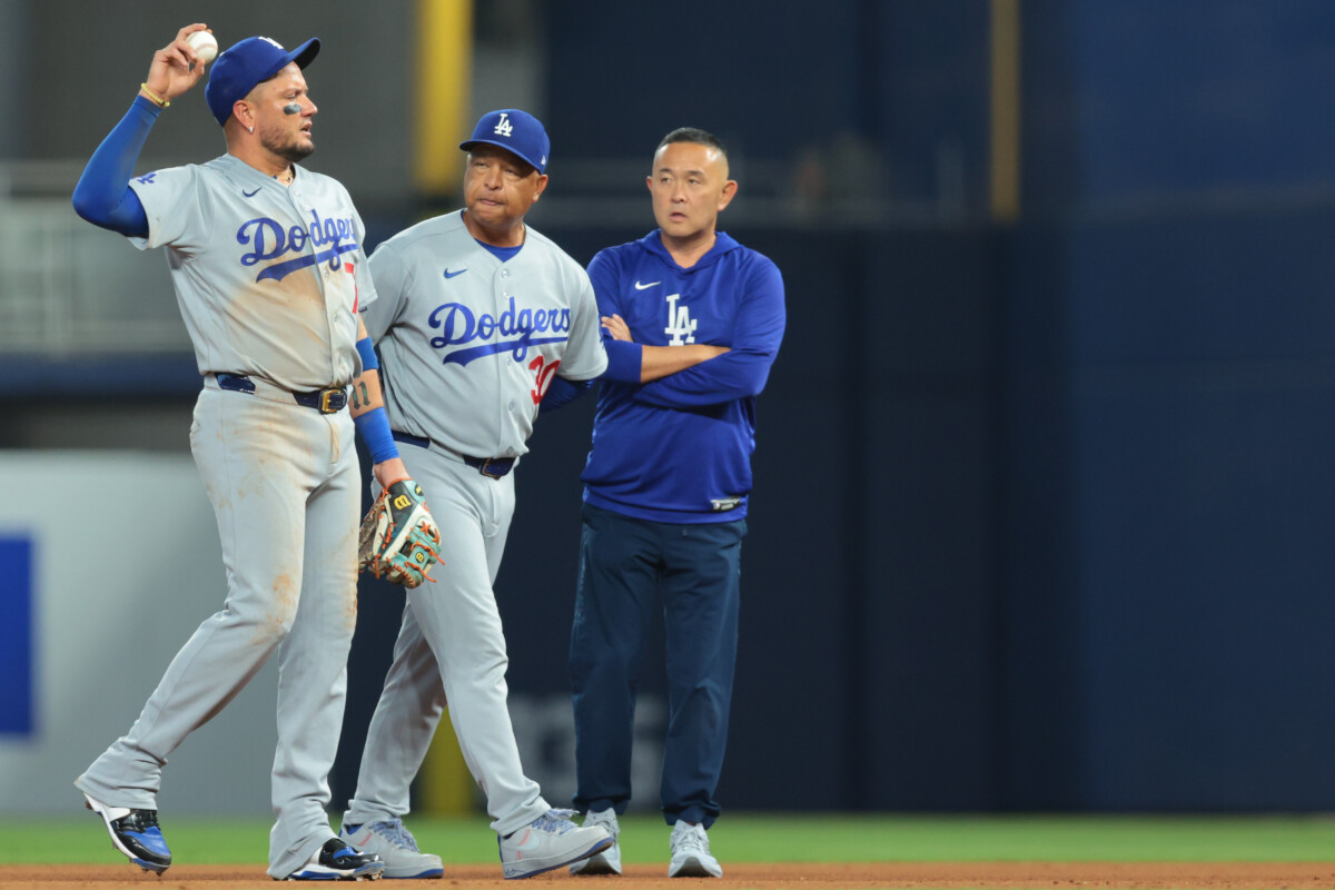 Sep 13, 2026; Miami, Florida, USA; Los Angeles Dodgers manager Dave Roberts (30) checks on second baseman Miguel Rojas (72) after a collision with shortstop Mookie Betts (not pictured) during the eighth inning at loanDepot Park. Mandatory Credit: Sam Navarro-Imagn Images