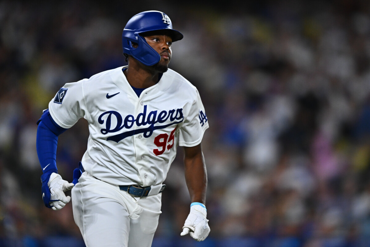 Sep 22, 2026; Los Angeles, California, USA; Los Angeles Dodgers designated hitter Josue De Paula (95) triples during the sixth inning against the San Diego Padres at Dodger Stadium. Mandatory Credit: William Liang-Imagn Images