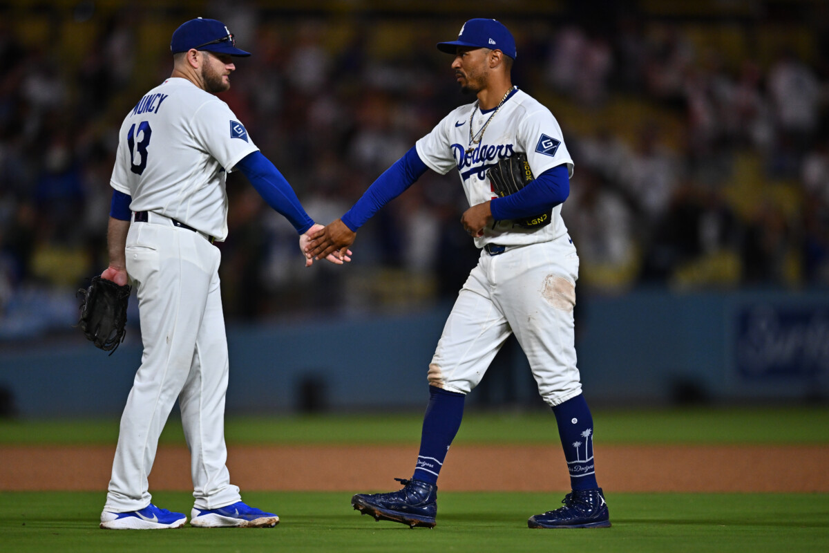 Sep 22, 2026; Los Angeles, California, USA; Los Angeles Dodgers shortstop Mookie Betts (50) celebrates with third baseman Max Muncy (13) after the win against the San Diego Padres at Dodger Stadium. Mandatory Credit: William Liang-Imagn Images