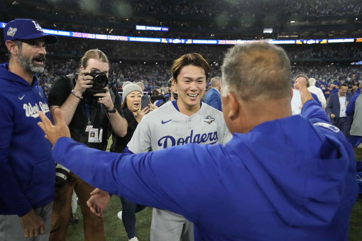 Nov 1, 2025; Toronto, Ontario, CAN; Los Angeles Dodgers pitcher Yoshinobu Yamamoto (18) celebrates with manager Dave Roberts (30) after defeating the Toronto Blue Jays in game seven of the 2025 MLB World Series at Rogers Centre. Mandatory Credit: John E. Sokolowski-Imagn Images
