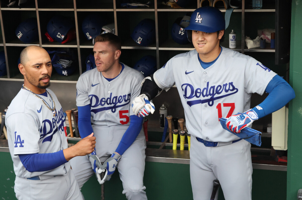 Jun 9, 2026; Pittsburgh, Pennsylvania, USA; Los Angeles Dodgers shortstop Mookie Betts (50) and designated hitter Shohei Ohtani (17) and first baseman Freddie Freeman (5) prepare in the dugout before the first inning against the Pittsburgh Pirates at PNC Park. Mandatory Credit: Charles LeClaire-Imagn Images