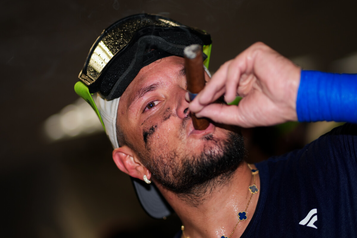 Sep 17, 2026; Cincinnati, Ohio, USA; Los Angeles Dodgers second baseman Miguel Rojas celebrates after clinching the National League West title after the game against the Cincinnati Reds at Great American Ball Park. Mandatory Credit: Aaron Doster-Imagn Images